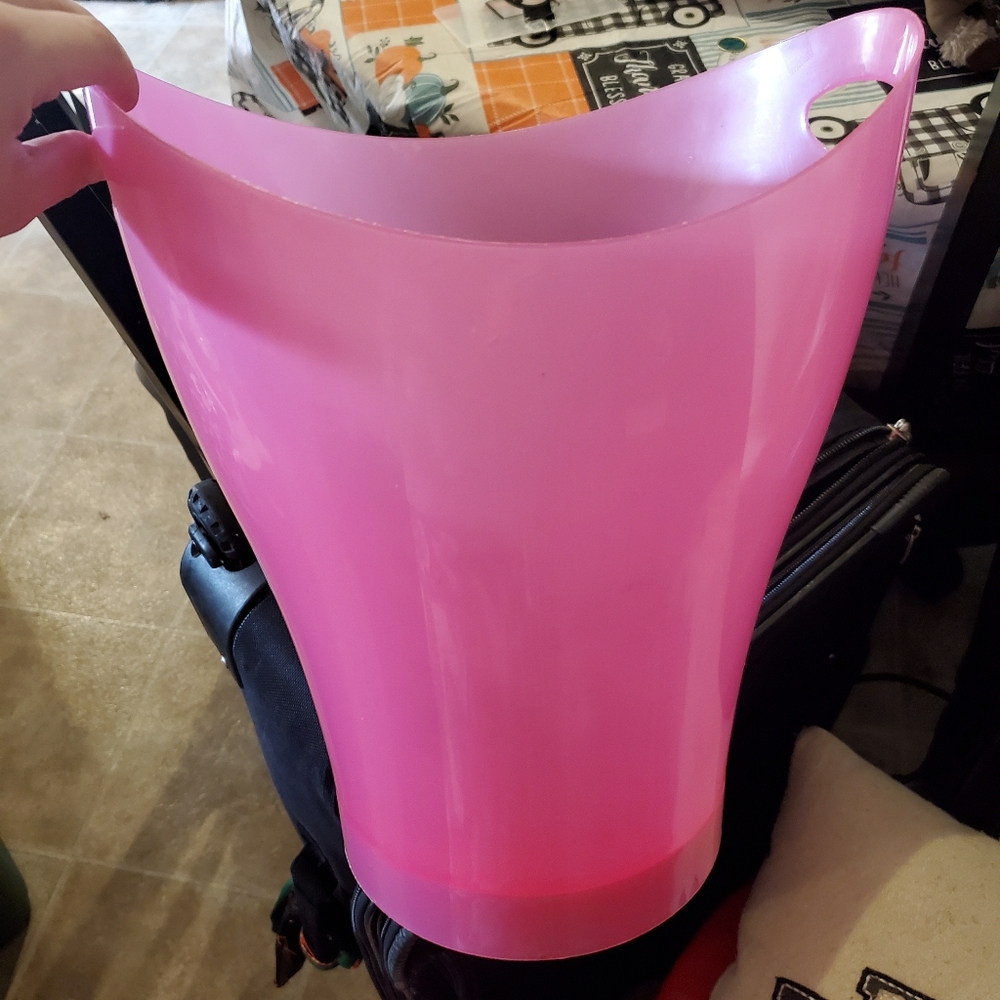 Pink plastic garbage bin